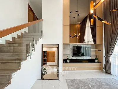 Luxurious modern living room with high ceilings and elegant staircase
