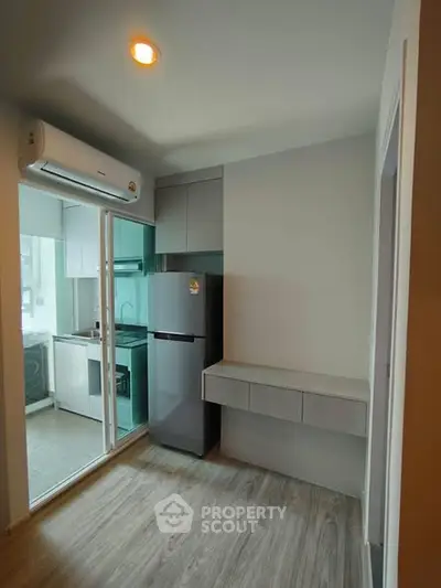 Modern kitchen with sleek cabinetry and stainless steel appliances in a compact layout.