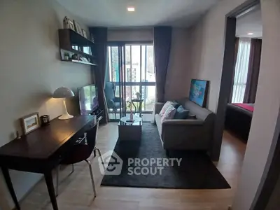 Modern living room with cozy sofa, stylish decor, and large window offering natural light.