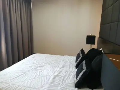 Cozy bedroom with modern decor and plush bedding in a stylish apartment.