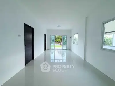 Spacious and bright living room with large windows and garden view