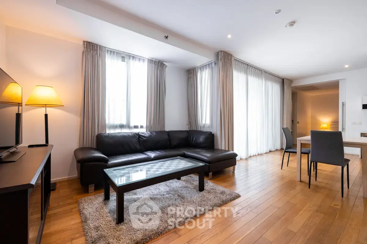 Spacious modern living room with wooden flooring and elegant furnishings