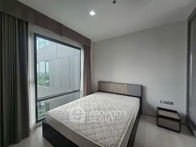 Modern bedroom with large window and minimalist design in urban apartment