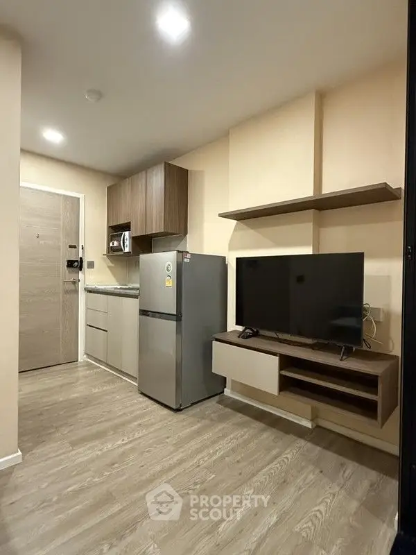 Modern compact living space with kitchen and entertainment area