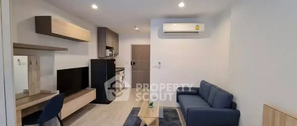 Modern living room with sleek furniture and integrated kitchen appliances.