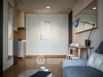 Modern living room with stylish decor and open kitchen layout in a cozy apartment.