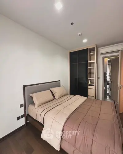 Modern bedroom with sleek design and built-in wardrobe in a stylish apartment.