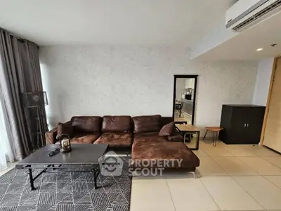 Spacious modern living room with brown leather sectional sofa and stylish decor