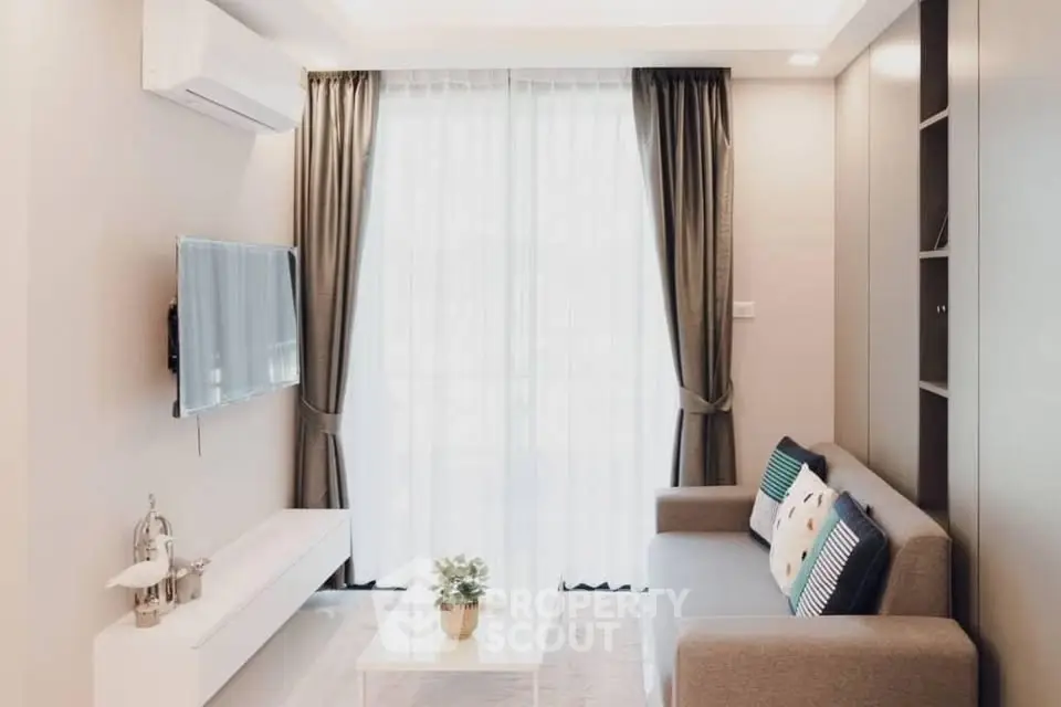 Modern living room with sleek design, featuring a wall-mounted TV, stylish sofa, and elegant curtains.
