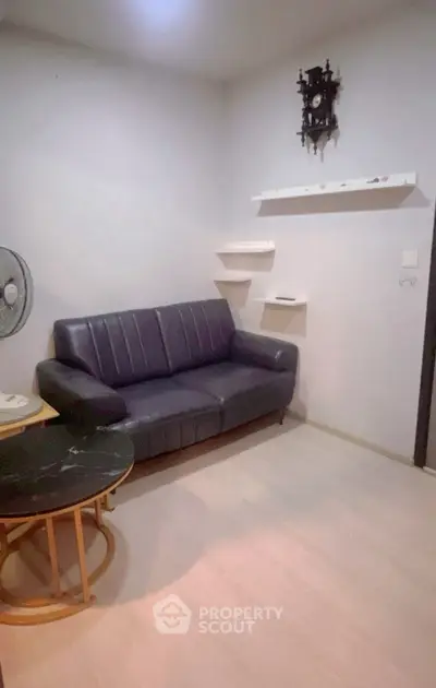 Cozy living room with leather sofa and wall-mounted shelves