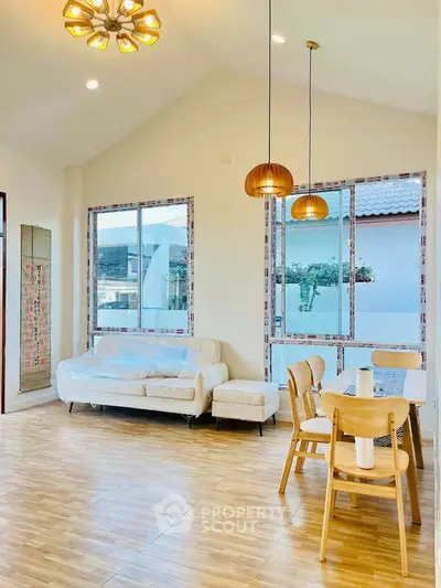 Bright and airy living room with modern furniture and large windows.