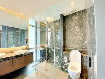 Luxurious modern bathroom with glass shower and dual sinks in elegant marble setting.