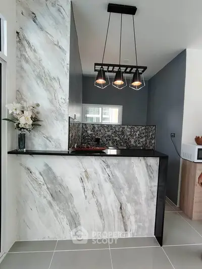 Modern kitchen with marble accents and stylish lighting