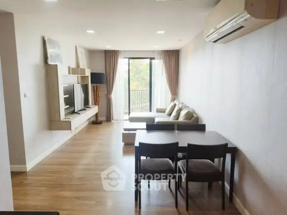 Spacious living room with modern decor and large window view.