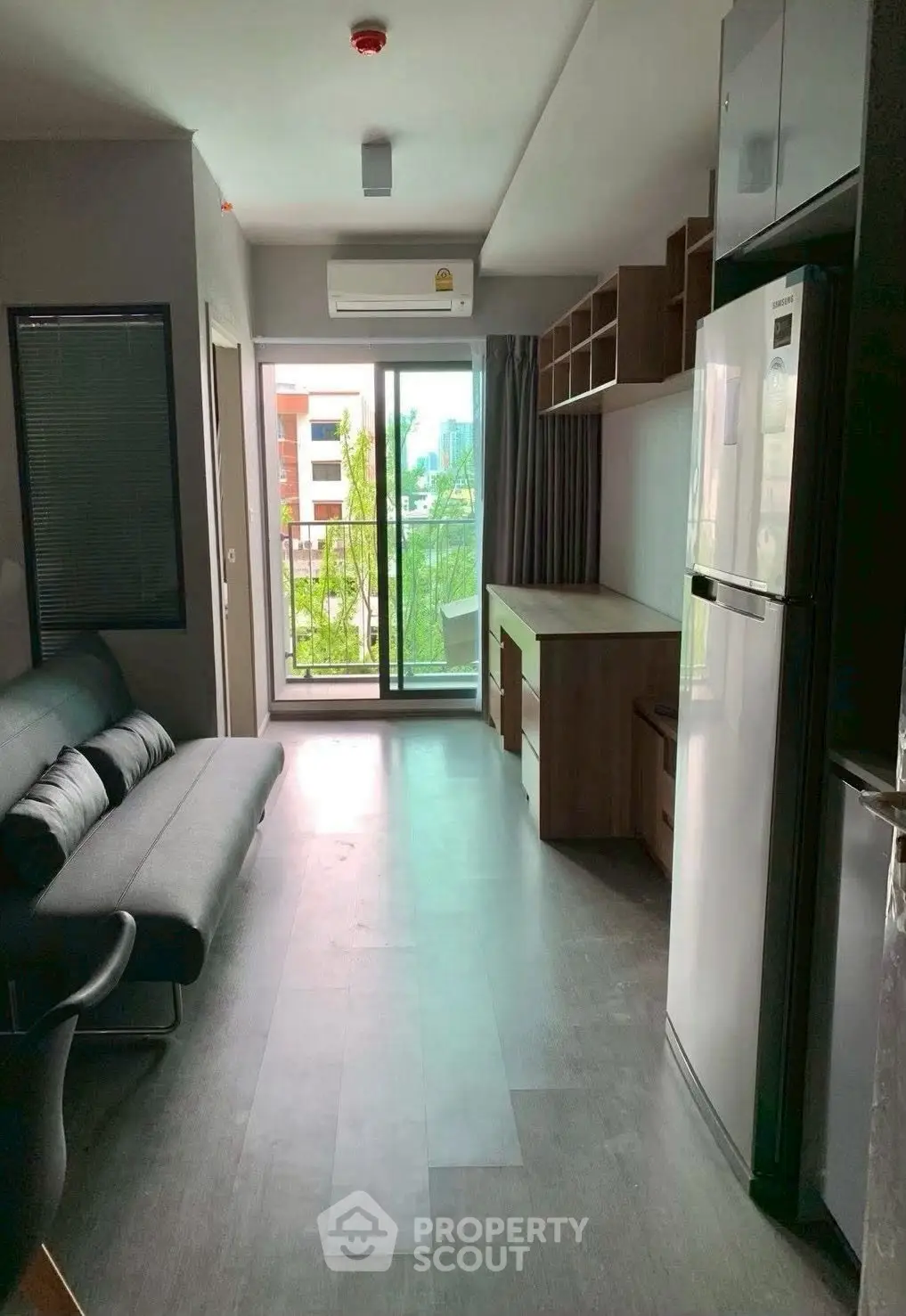 Modern apartment living room with balcony and sleek furnishings