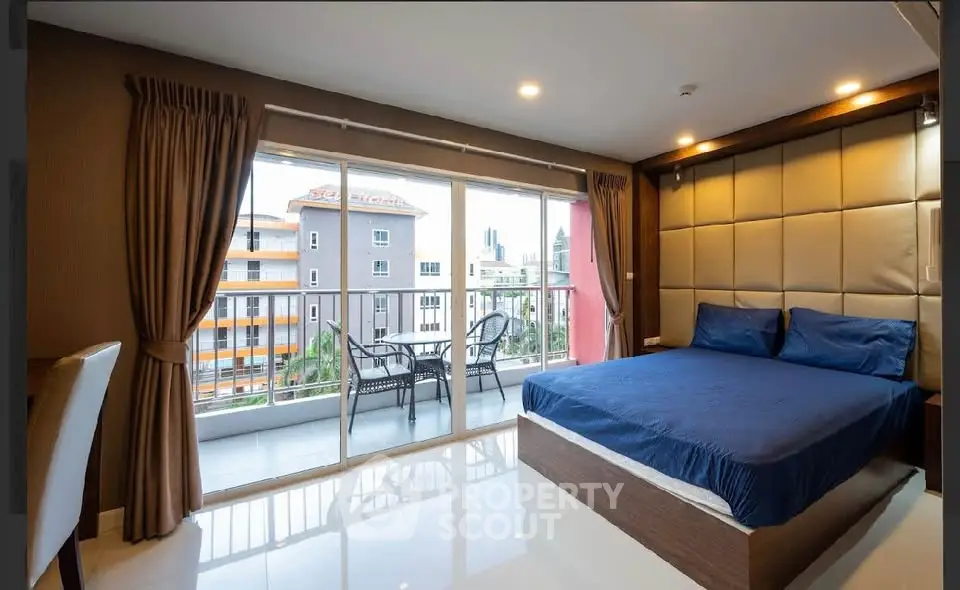 Spacious bedroom with balcony view in modern apartment