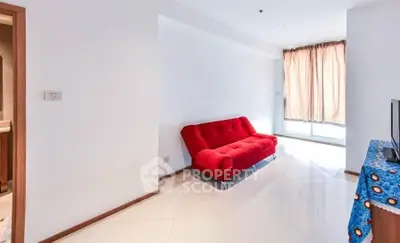 Bright living room with red sofa and large window, perfect for relaxation and entertainment.
