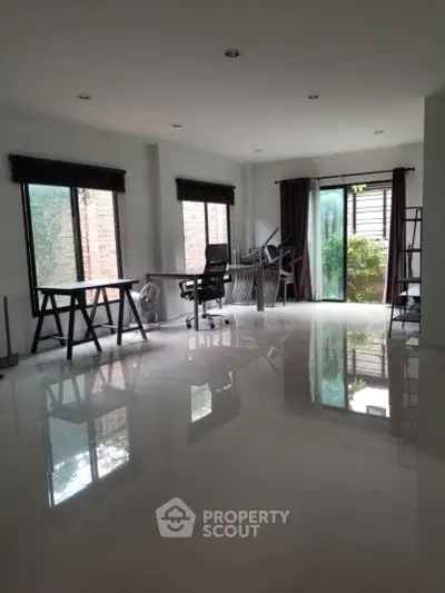 Spacious modern study with large windows and sleek furniture, perfect for productivity.