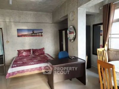 Cozy bedroom with modern decor and workspace in a stylish apartment.