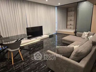 Modern living room with sleek black flooring and stylish furniture