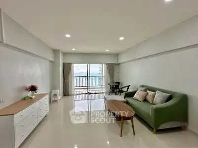 Spacious living room with sea view balcony and modern furniture