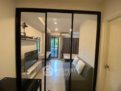 Modern apartment interior with open layout, featuring a cozy living area and bedroom with balcony access.