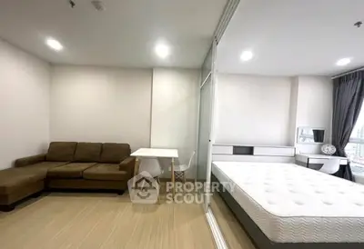 Modern studio apartment with cozy living area and comfortable bedroom