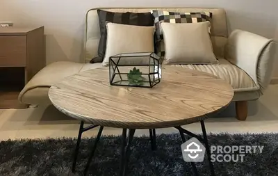 Chic modern living room with stylish sofa and wooden coffee table, complemented by plush area rug and minimalist decor.