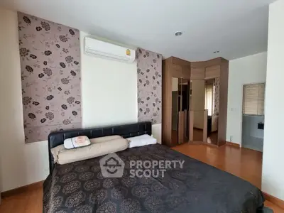 Spacious bedroom with modern decor and large bed in a stylish apartment.