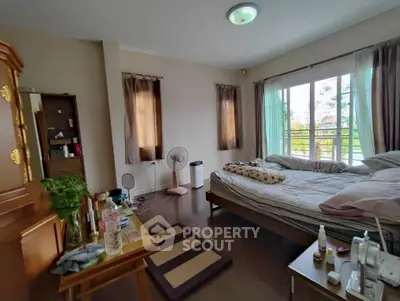 Spacious bedroom with large windows and natural light