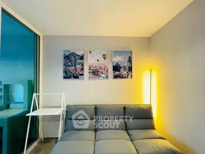 Modern living room with stylish sofa and artistic wall decor, featuring a cozy ambiance and sleek design.