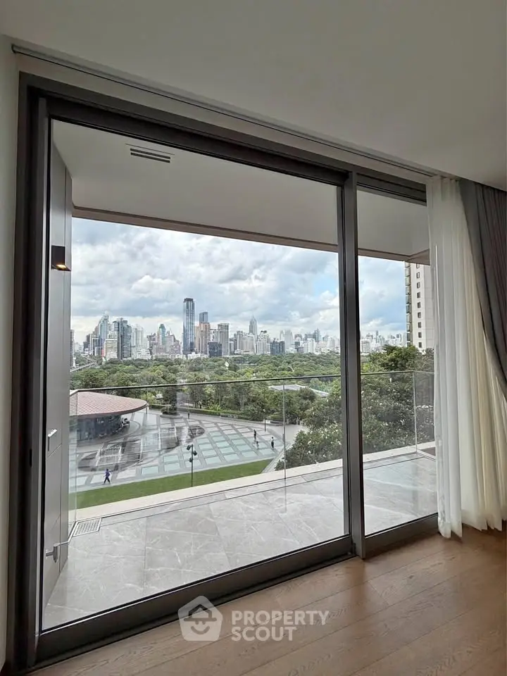 Luxurious apartment with stunning city skyline view from spacious balcony.
