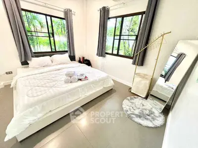 Bright and airy bedroom with large windows and modern decor