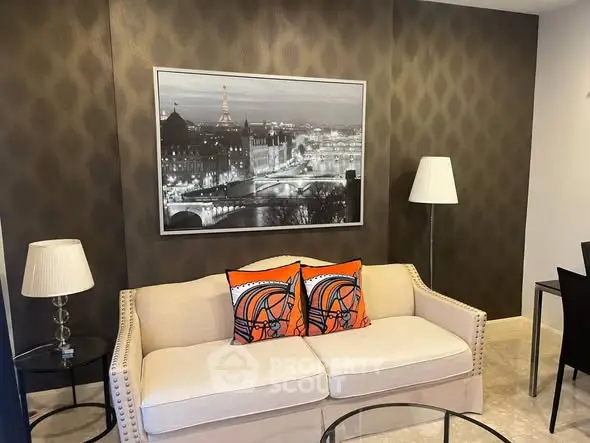 Stylish living room with elegant decor and modern furniture, featuring a chic sofa and artistic wall art.