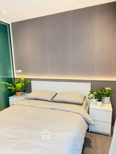 Modern bedroom with sleek design and ambient lighting, featuring a cozy bed and stylish decor.