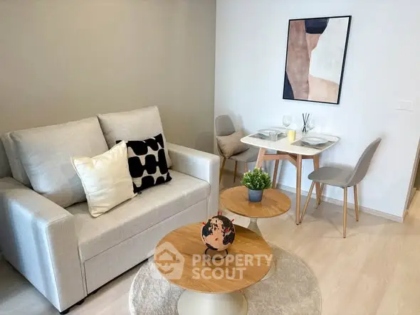 Modern living room with cozy sofa and stylish dining area.