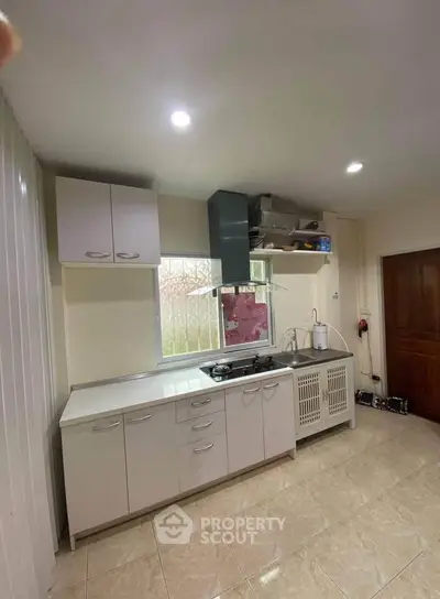 Modern kitchen with sleek cabinetry and gas stove, perfect for culinary enthusiasts.