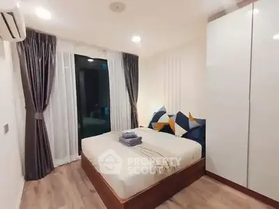 Cozy modern bedroom with stylish decor and ample natural light