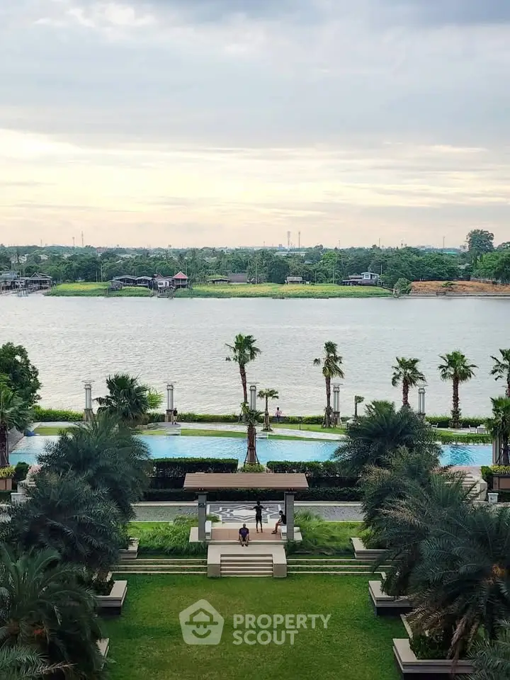 Luxurious riverside property with stunning pool and lush gardens offering serene views.