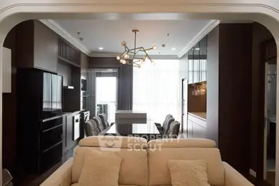 Luxurious modern living room with elegant dining area and stylish lighting fixture.