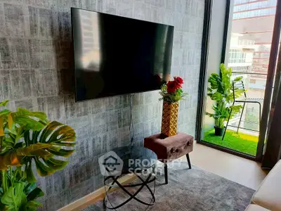 Modern living room with wall-mounted TV and balcony view