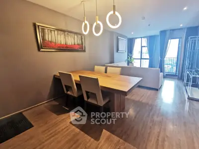 Modern living room with elegant dining area and stylish lighting in a contemporary apartment.