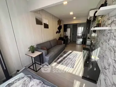 Modern living room with stylish decor and natural light in a contemporary apartment.