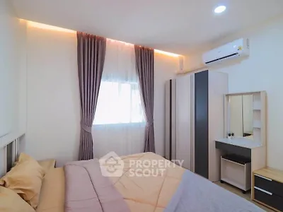 Cozy bedroom with modern decor, featuring a comfortable bed, stylish curtains, and a sleek air conditioning unit.