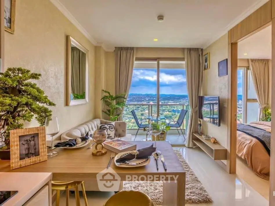 Stylish open-plan living room with dining area and balcony offering stunning views.