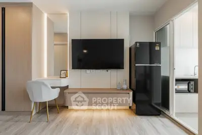 Modern living room with sleek TV setup and stylish furniture in a contemporary apartment.
