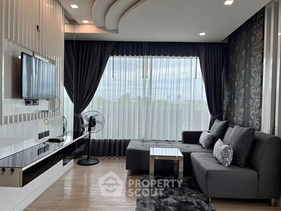 Modern living room with stylish decor and large windows offering natural light and scenic views.
