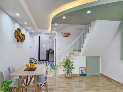 Modern dining area with stylish decor and staircase in a contemporary home
