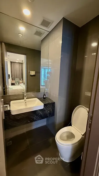Modern bathroom with sleek design and contemporary fixtures in a stylish apartment.