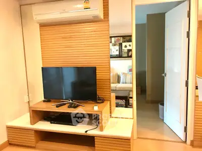 Modern living room with TV and air conditioning in stylish apartment